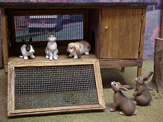 hand carved wood miniature bunnies with hand made hutch.