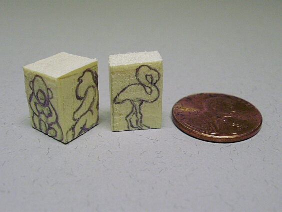 Animals drawn on tiny blocks of wood.